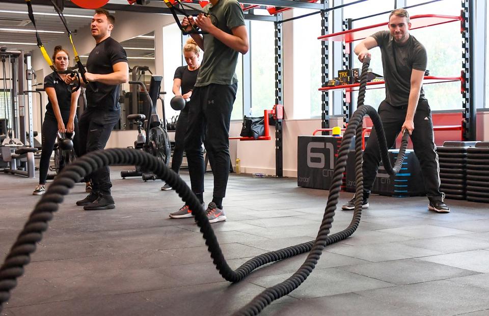 A group of people doing weight exercises at the Solent gym